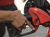 image of man pumping gas at gas station