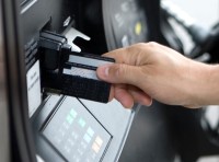 image of hand paying at a gas pump with a credit card