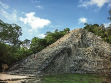 image of two people walking up ruins in Western Caribbean